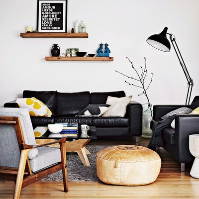 Example of a danish medium tone wood floor and beige floor family room design in Other with white walls