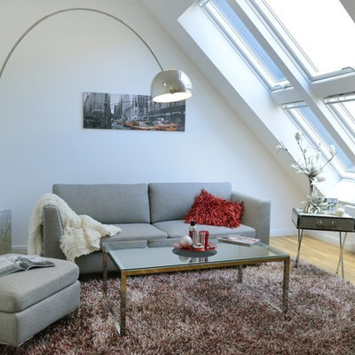 Inspiration for a small scandinavian enclosed light wood floor family room remodel in Berlin with white walls and no fireplace