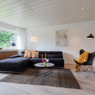 Modernes Wohnzimmer mit weißer Wandfarbe und grauem Boden in Köln