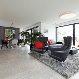 Großes, Fernseherloses, Offenes Modernes Wohnzimmer mit weißer Wandfarbe, Kamin, verputzter Kaminumrandung und beigem Boden in Stuttgart