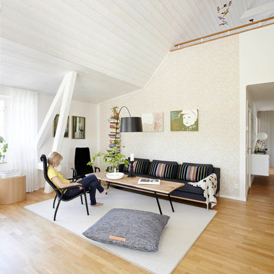 Inspiration for a large scandinavian light wood floor family room remodel in Bremen with beige walls, no fireplace and no tv