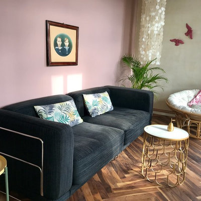 Inspiration for a small eclectic open concept medium tone wood floor and brown floor family room remodel in Berlin with multicolored walls and no fireplace