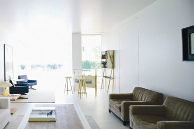 Geräumiges, Fernseherloses Modernes Wohnzimmer ohne Kamin, im Loft-Stil mit Hausbar, weißer Wandfarbe, Betonboden und grauem Boden in München