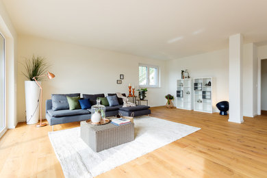 Großes, Fernseherloses, Abgetrenntes Wohnzimmer ohne Kamin mit weißer Wandfarbe, braunem Holzboden und braunem Boden in Dortmund