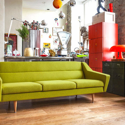 Example of a mid-sized eclectic open concept laminate floor and brown floor family room design in Stuttgart with white walls, no fireplace and no tv