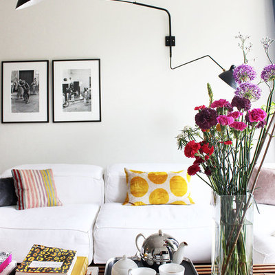 Family room - mid-sized eclectic enclosed medium tone wood floor and brown floor family room idea in Hamburg with white walls