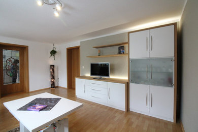 Foto på ett mellanstort funkis separat vardagsrum, med en fristående TV, en hemmabar, vita väggar, ljust trägolv och beiget golv