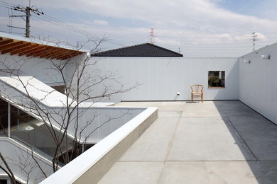 Diseño de terraza minimalista en azotea con brasero