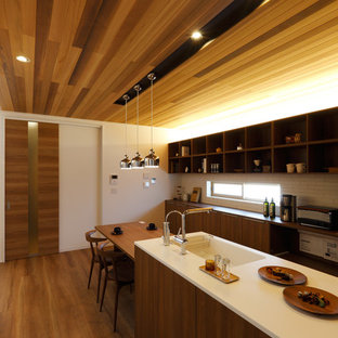 Inspiration for an asian galley kitchen in Other with an integrated sink, flat-panel cabinets, medium wood cabinets, white splashback, medium hardwood floors and brown floor.
