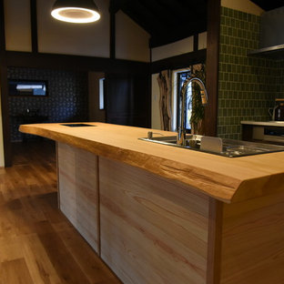 This is an example of a large asian galley open plan kitchen in Other with open cabinets, medium wood cabinets, wood benchtops, porcelain splashback, stainless steel appliances, medium hardwood floors and with island.