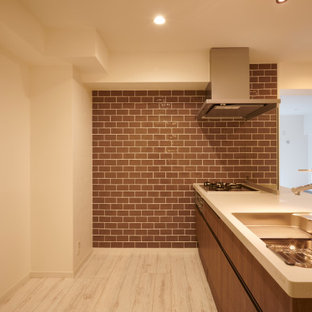 This is an example of a small contemporary single-wall eat-in kitchen in Tokyo with an undermount sink, solid surface benchtops, brown splashback, porcelain splashback, panelled appliances, plywood floors, with island, white floor and brown benchtop.