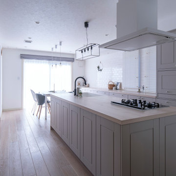 納入事例：白を基調とした空間に佇むのは、ミンクグレーの框扉を使ったクラシカルなキッチン