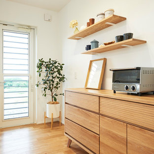 Mid-sized scandinavian single-wall open plan kitchen in Other with an integrated sink, beaded inset cabinets, light wood cabinets, solid surface benchtops, white splashback, light hardwood floors, no island, multi-coloured floor and white benchtop.