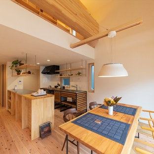 Asian medium tone wood floor and brown floor great room photo in Yokohama with white walls