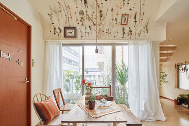 Inspiration for a small farmhouse open plan dining room in Tokyo with white walls, light hardwood flooring and no fireplace.