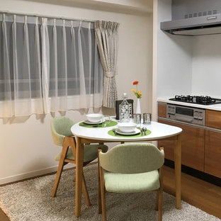 Inspiration för små matplatser med öppen planlösning, med vita väggar, plywoodgolv och brunt golv
