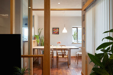 Modern dining room in Other with medium hardwood flooring.