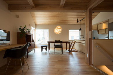 This is an example of a dining room in Tokyo Suburbs with white walls, light hardwood flooring and beige floors.