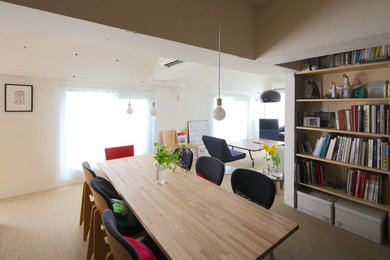 This is an example of a modern open plan dining room in Tokyo with white walls, carpet and no fireplace.