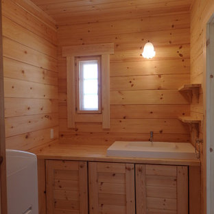 Photo of a scandinavian powder room in Other with light hardwood floors and a drop-in sink.