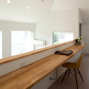 Idéer för att renovera ett mellanstort funkis hobbyrum, med vita väggar, plywoodgolv, ett inbyggt skrivbord och beiget golv