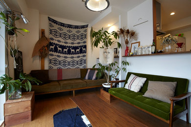 Immagine di un piccolo soggiorno eclettico con pareti bianche, pavimento in legno massello medio, nessun camino e TV autoportante