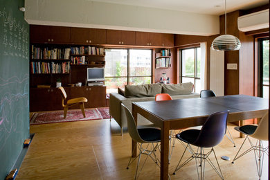 This is an example of a bohemian open plan living room in Tokyo with brown walls, medium hardwood flooring, no fireplace and a freestanding tv.