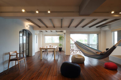 Modelo de salón para visitas abierto de estilo zen de tamaño medio sin chimenea y televisor con paredes blancas y suelo de madera oscura