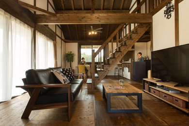 Ejemplo de salón abierto de estilo zen con paredes blancas, suelo de madera en tonos medios, televisor independiente y suelo marrón