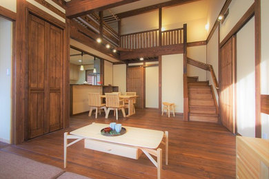 Medium sized world-inspired open plan living room in Other with dark hardwood flooring, white walls and brown floors.