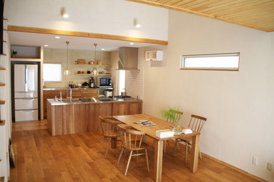 Open concept medium tone wood floor and brown floor living room photo in Kobe with white walls