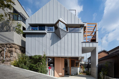 Trendy gray three-story exterior home photo in Kobe