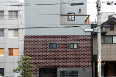 На фото: трехэтажный, серый таунхаус среднего размера в стиле рустика с облицовкой из цементной штукатурки