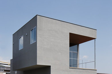 Modelo de fachada de casa gris minimalista de dos plantas con tejado plano