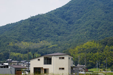 他の地域にあるアジアンスタイルのおしゃれな家の外観 (石材サイディング) の写真