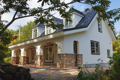 Inspiration for a white rural two floor detached house with a pitched roof and a tiled roof.