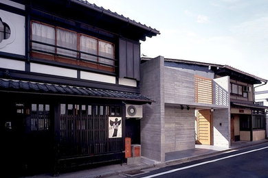 Imagen de fachada de casa de estilo zen de dos plantas con tejado de teja de barro