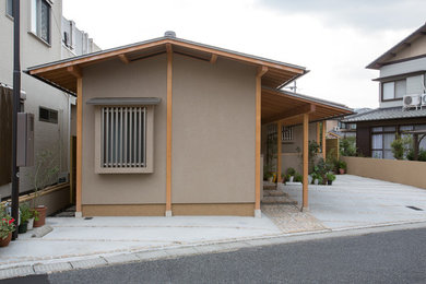 This is an example of a small and beige world-inspired bungalow detached house in Other with a pitched roof and a metal roof.