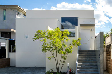 Ejemplo de fachada de casa blanca moderna de una planta con tejado plano