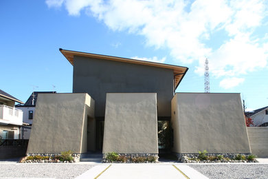 Diseño de fachada de casa gris de estilo zen con tejado de un solo tendido y tejado de metal