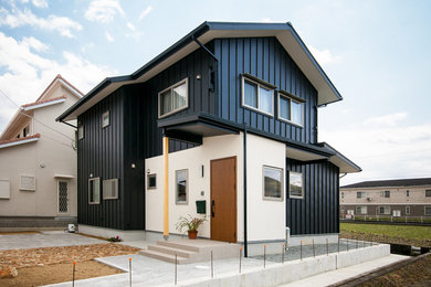 Diseño de fachada de casa negra moderna de dos plantas con revestimientos combinados