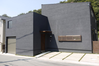 Ispirazione per la facciata di una casa grande blu moderna a due piani con rivestimento in stucco e copertura in metallo o lamiera