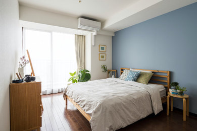 東京23区にある広い北欧スタイルのおしゃれな主寝室 (青い壁、濃色無垢フローリング) のインテリア