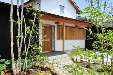 Idee per un giardino etnico esposto in pieno sole davanti casa con pavimentazioni in pietra naturale e un ingresso o sentiero