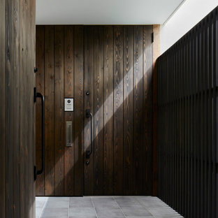 Foto de entrada urbana con paredes marrones, puerta simple y puerta de madera oscura