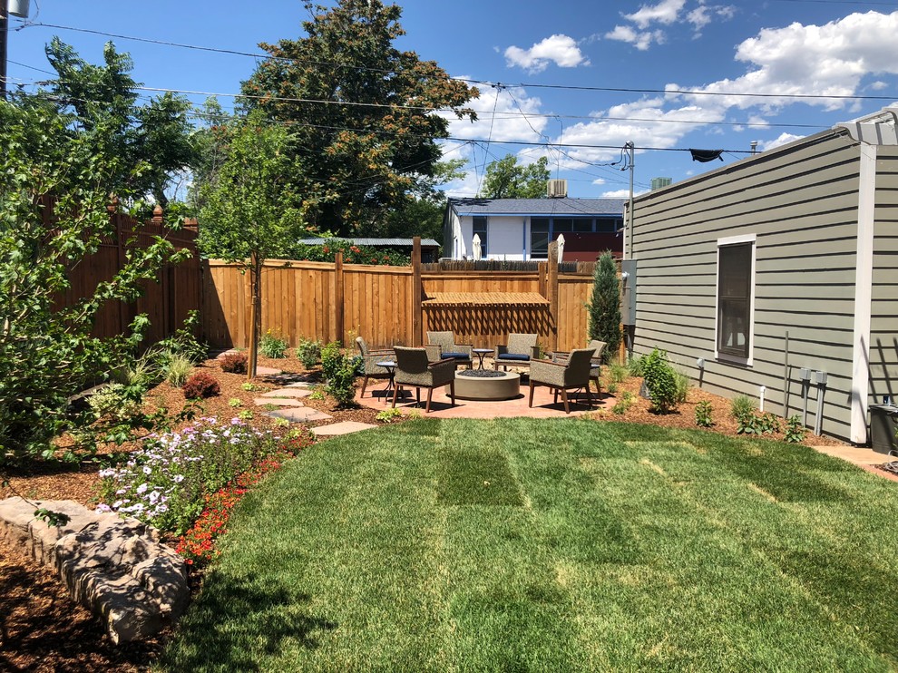 Photo of a large traditional backyard full sun garden for summer in Denver with brick pavers.