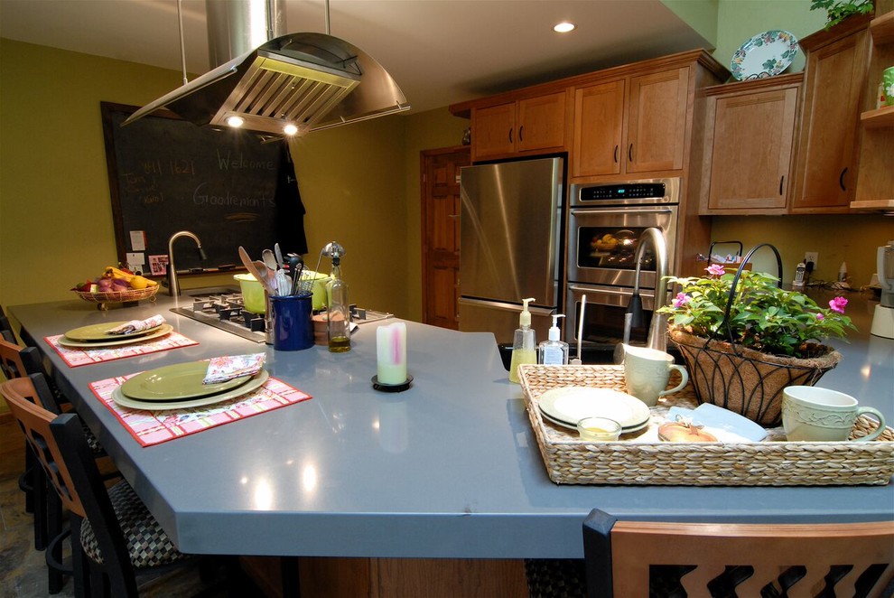 Inspiration for a large transitional l-shaped slate floor and multicolored floor open concept kitchen remodel with an undermount sink, shaker cabinets, medium tone wood cabinets, quartz countertops, stainless steel appliances, an island and gray countertops
