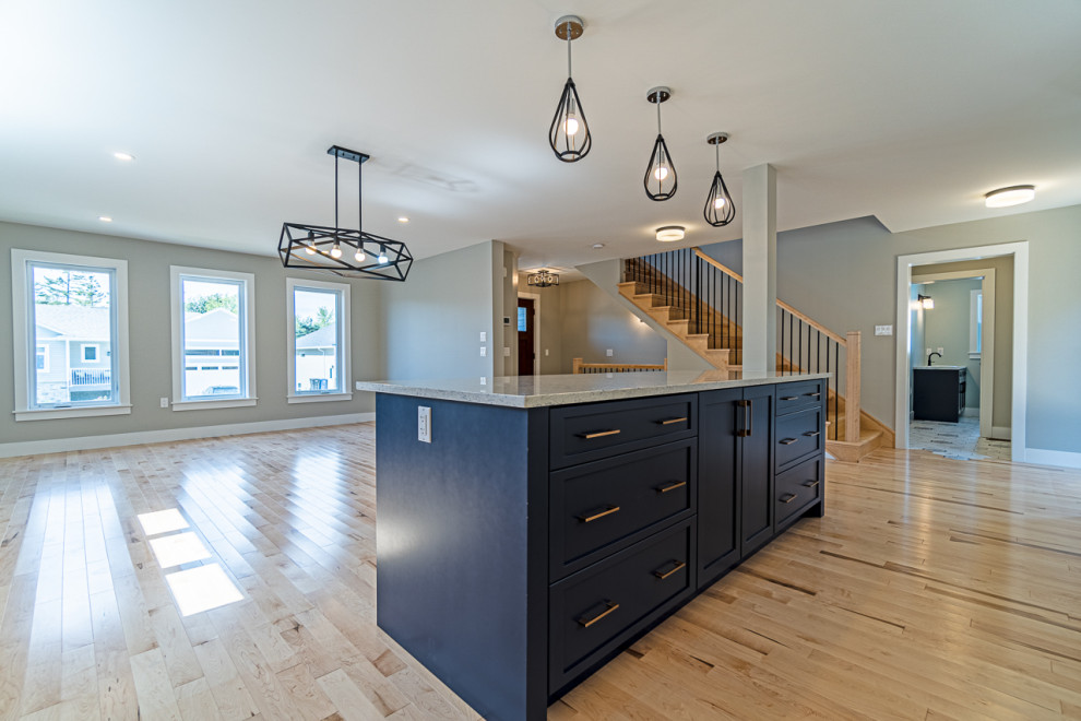 Eat-in kitchen - mid-sized transitional light wood floor and beige floor eat-in kitchen idea with an undermount sink, shaker cabinets, white cabinets, granite countertops, white backsplash, ceramic backsplash, stainless steel appliances, an island and gray countertops
