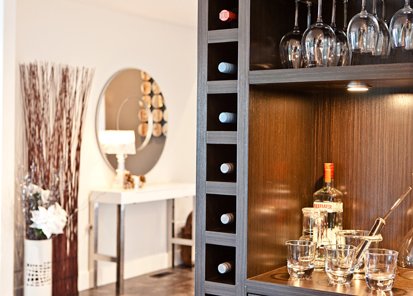 Design ideas for a small contemporary wine cellar in Vancouver with dark hardwood floors, storage racks and brown floor.