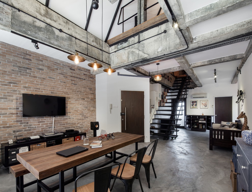 Industrial open plan dining in Singapore with white walls, concrete floors and no fireplace.